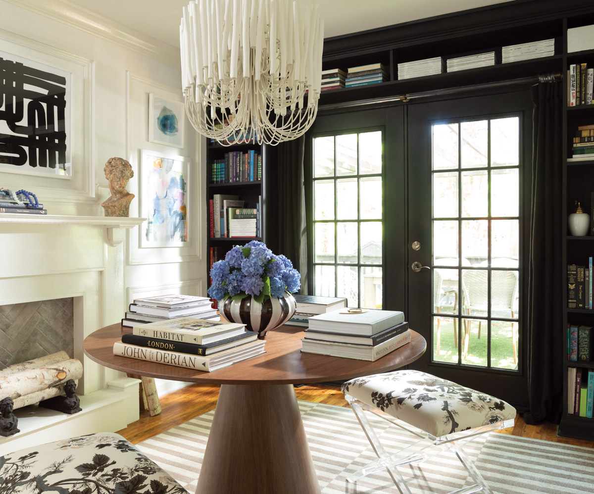 A beautifully sun-lit room with a chandelier and book shelf