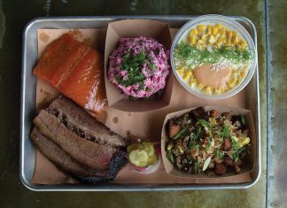 A plate of salmon, brisket, and three delicious sides