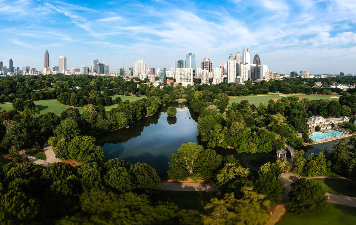 City skyline of Atlanta with Piedmont Park and the lake in the morning sun