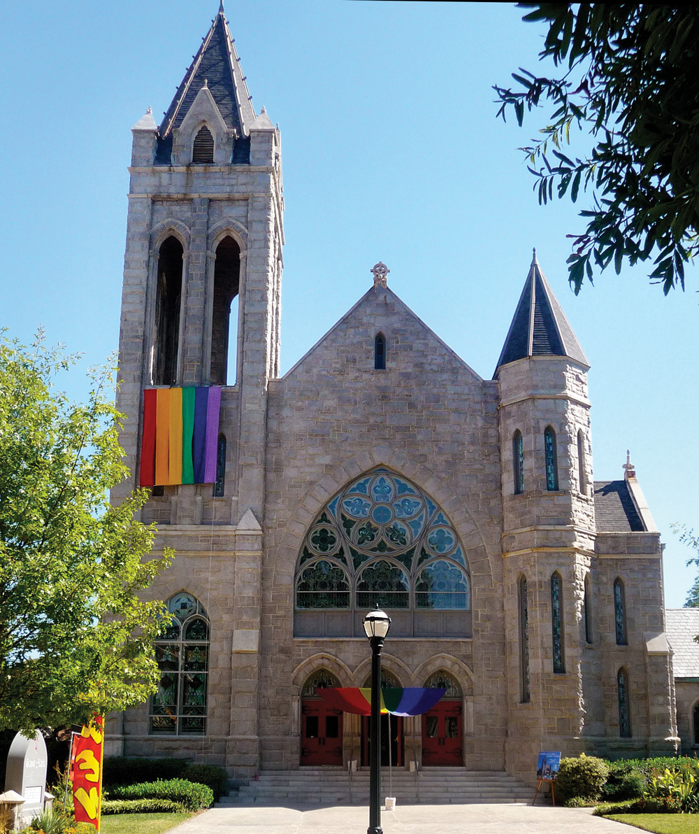 Saint Mark Church with a pride flag hanging from it