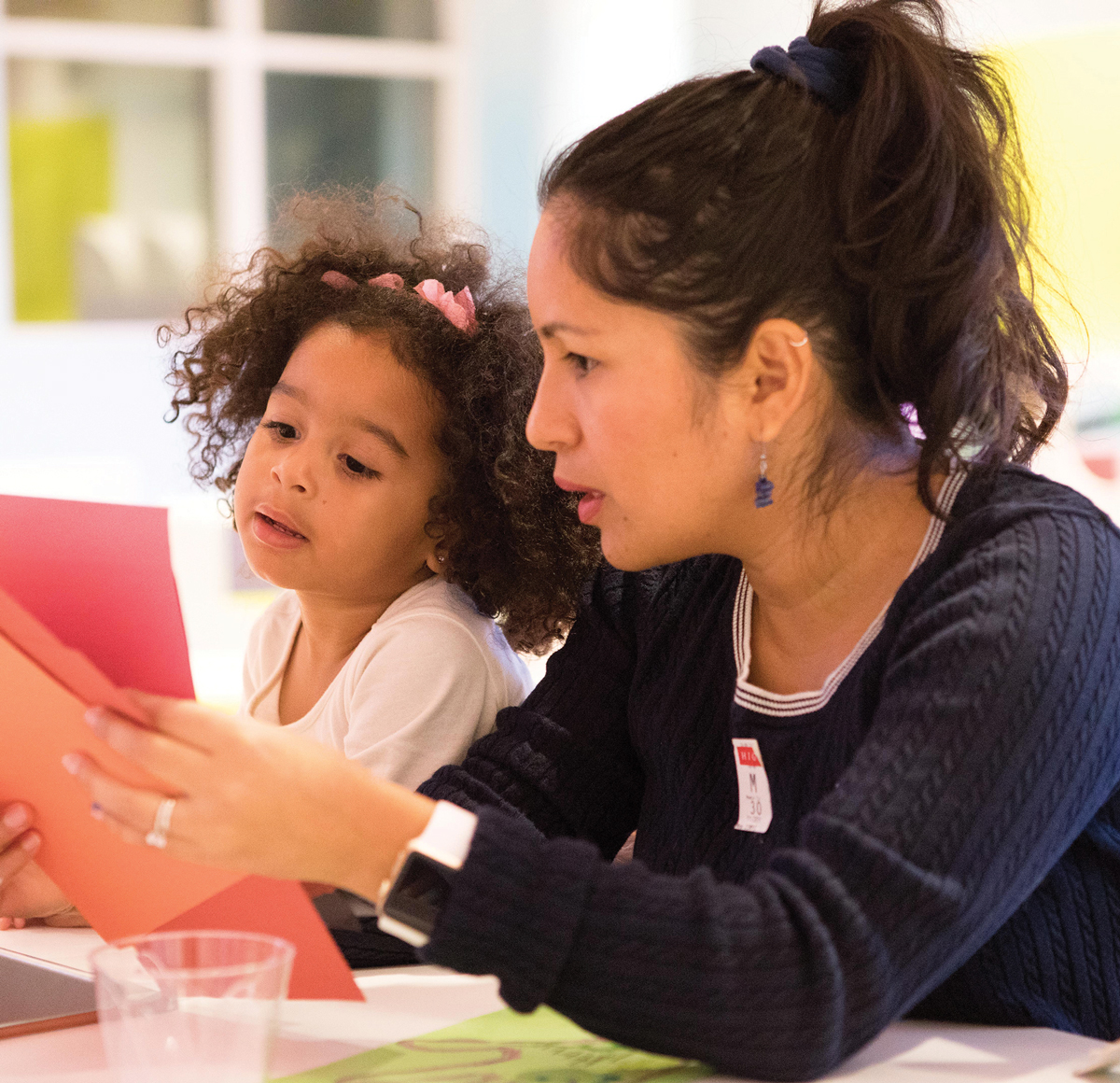 A woman working with a girl on a crafts project at the High Museum of Art