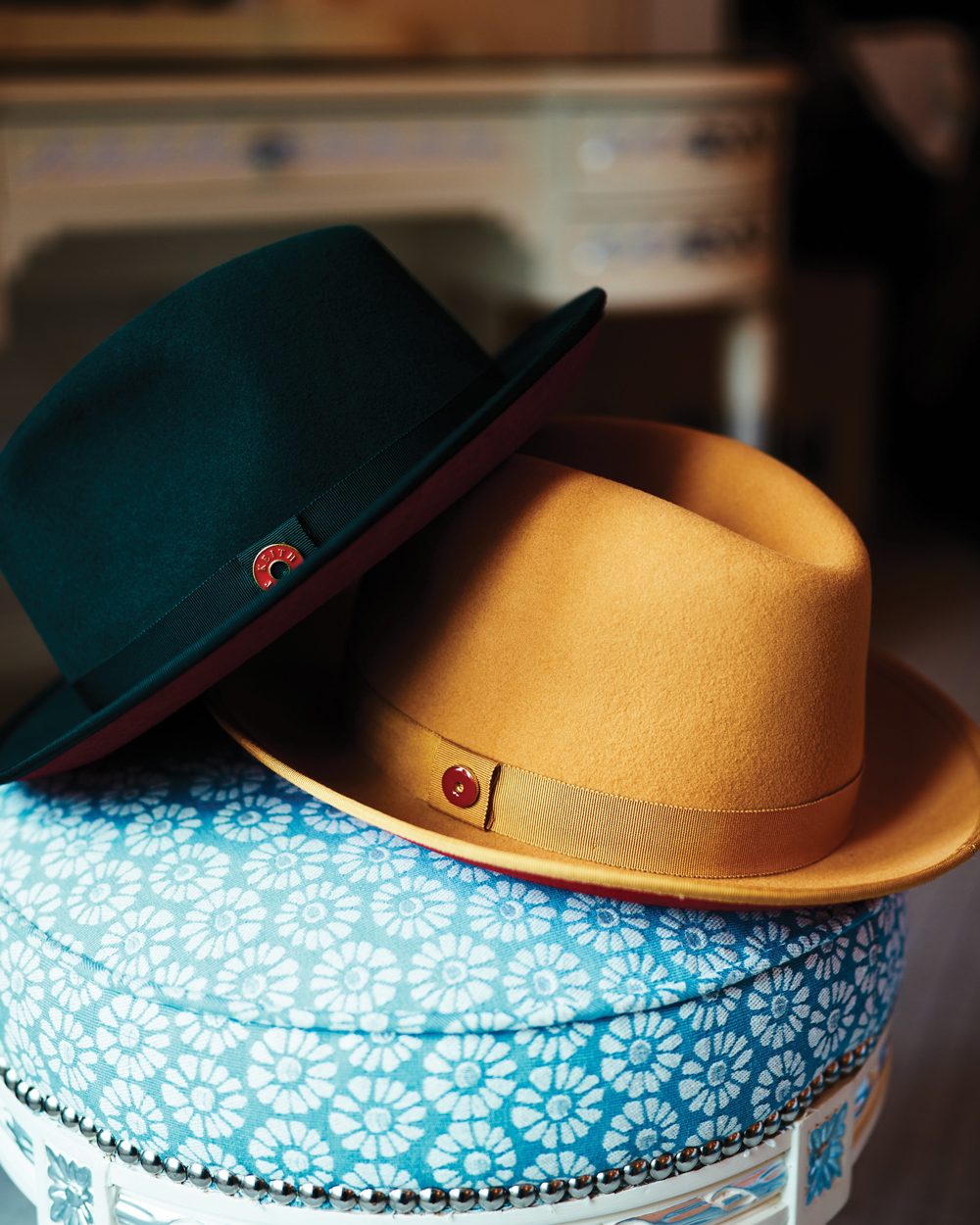 The King, a center-adorned fedora, is shown in canary yellow and mean green