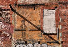 A faded 20th-century advertisement, revealed after a tornado, is a visual reminder of Atlanta’s complicated past