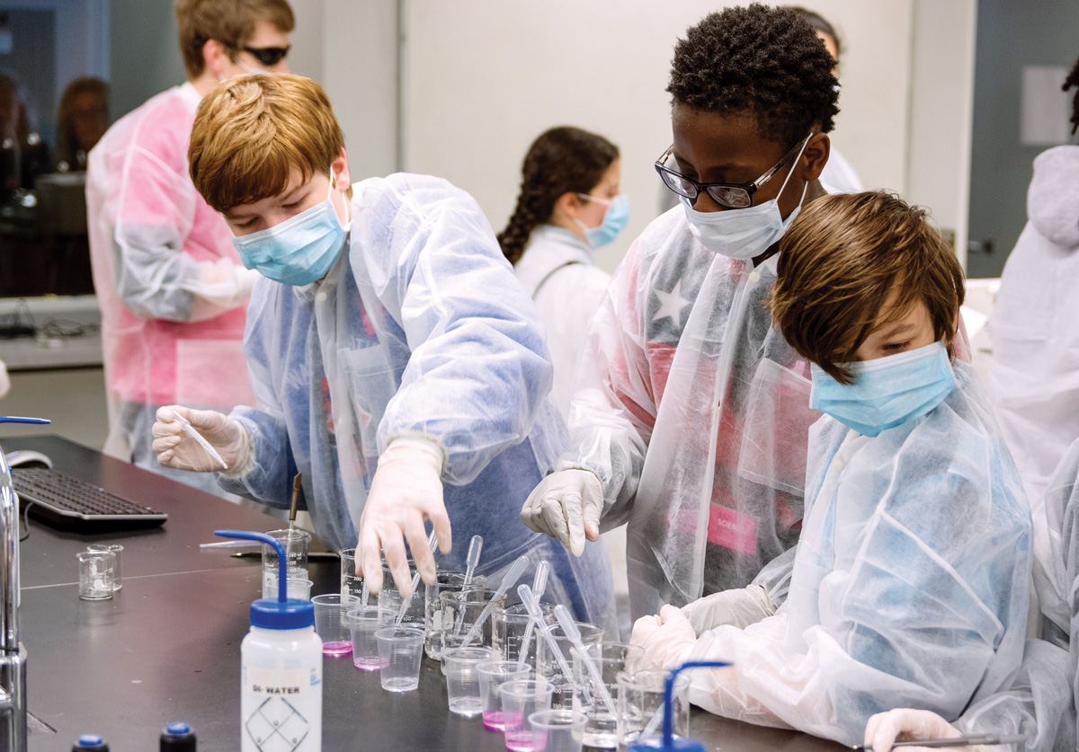 Kids in lab coats identifying the pathogen behind a mock zombie outbreak