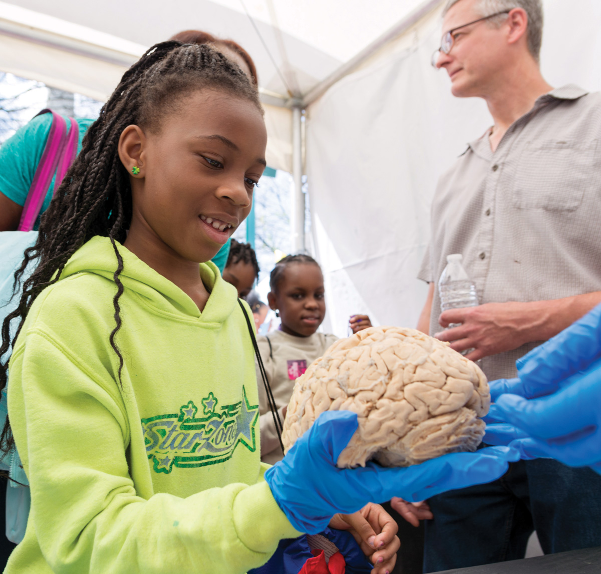 A girl holding a real human brain