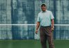 Horace Reid stands on a tennis court