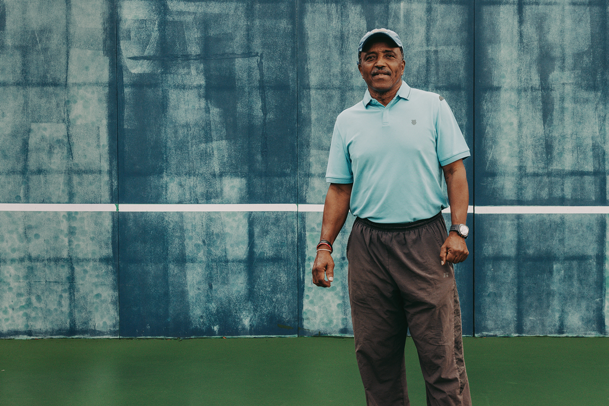 Horace Reid stands on a tennis court