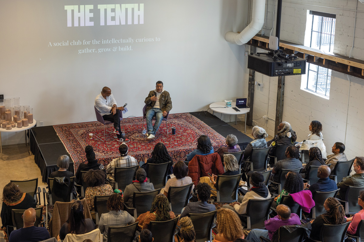 The Tenth cofounder Clint Fluker sits next to Mike Jordan, speaking to attendees at the event