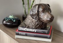 one of Dorri Buchholtz's dog artworks sits a top some books