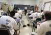 a classroom of inmates sit and listen