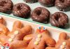 Rows of glazed, chocolate glazed, and gingerbread-shaped glazed donuts