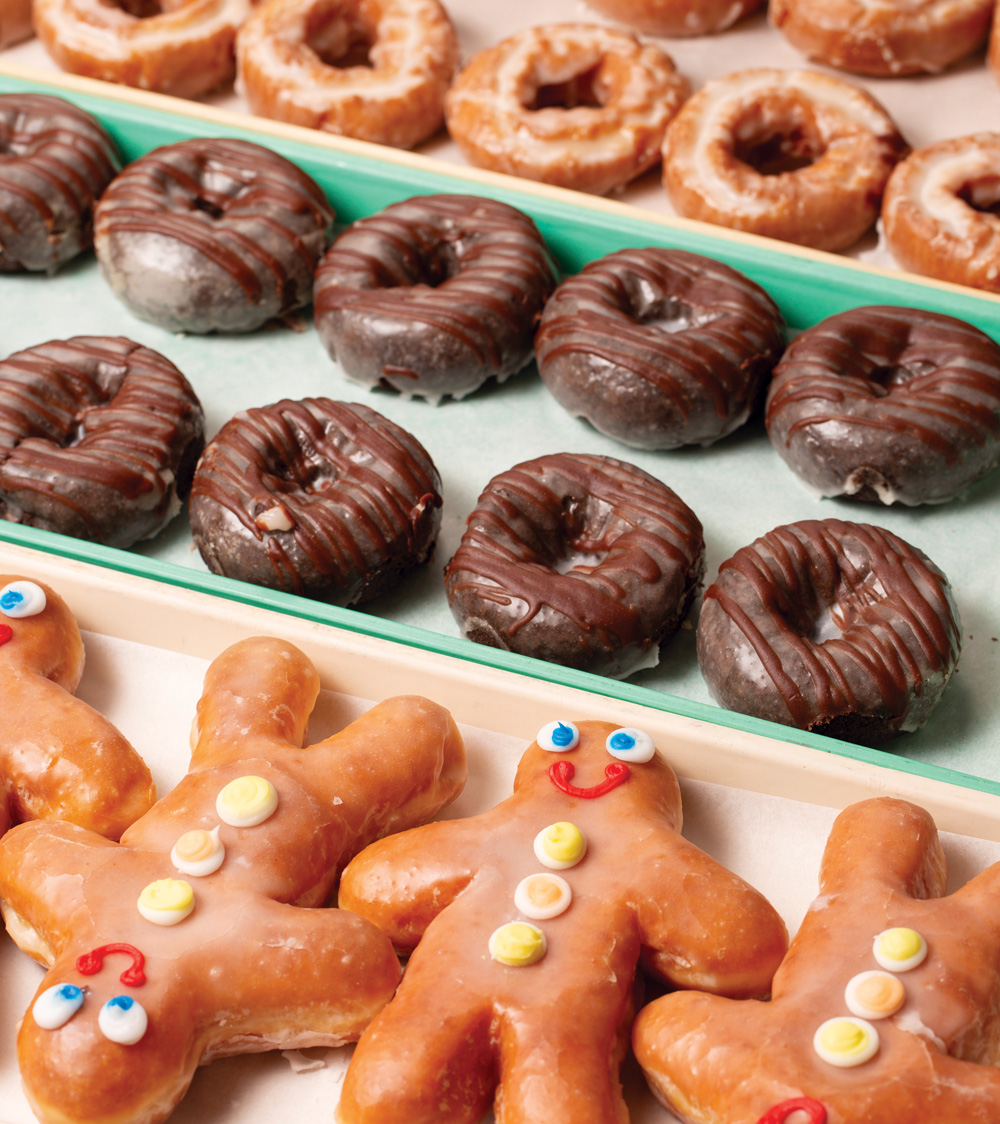 rows of glazed, chocolate glazed, and gingerbread-shaped glazed donuts