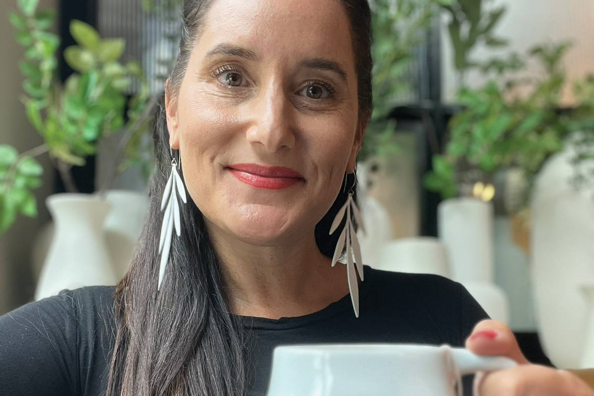 Molly Sanyour at her studio with one of her butt mugs in hand