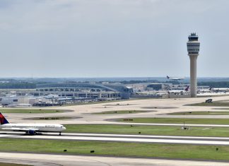 A Delta plane sits on the Atlanta Airport runway, ready to take off