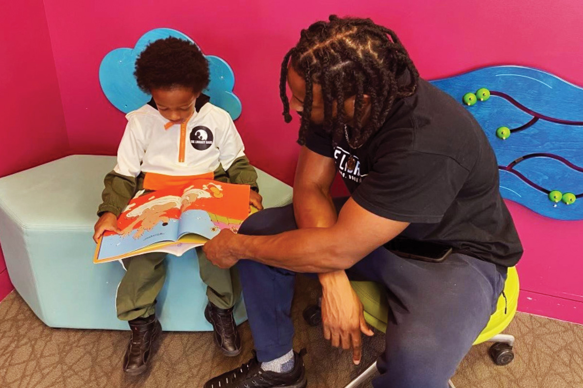 Michael Worthen, a member of The Library Dads, reads with his son.