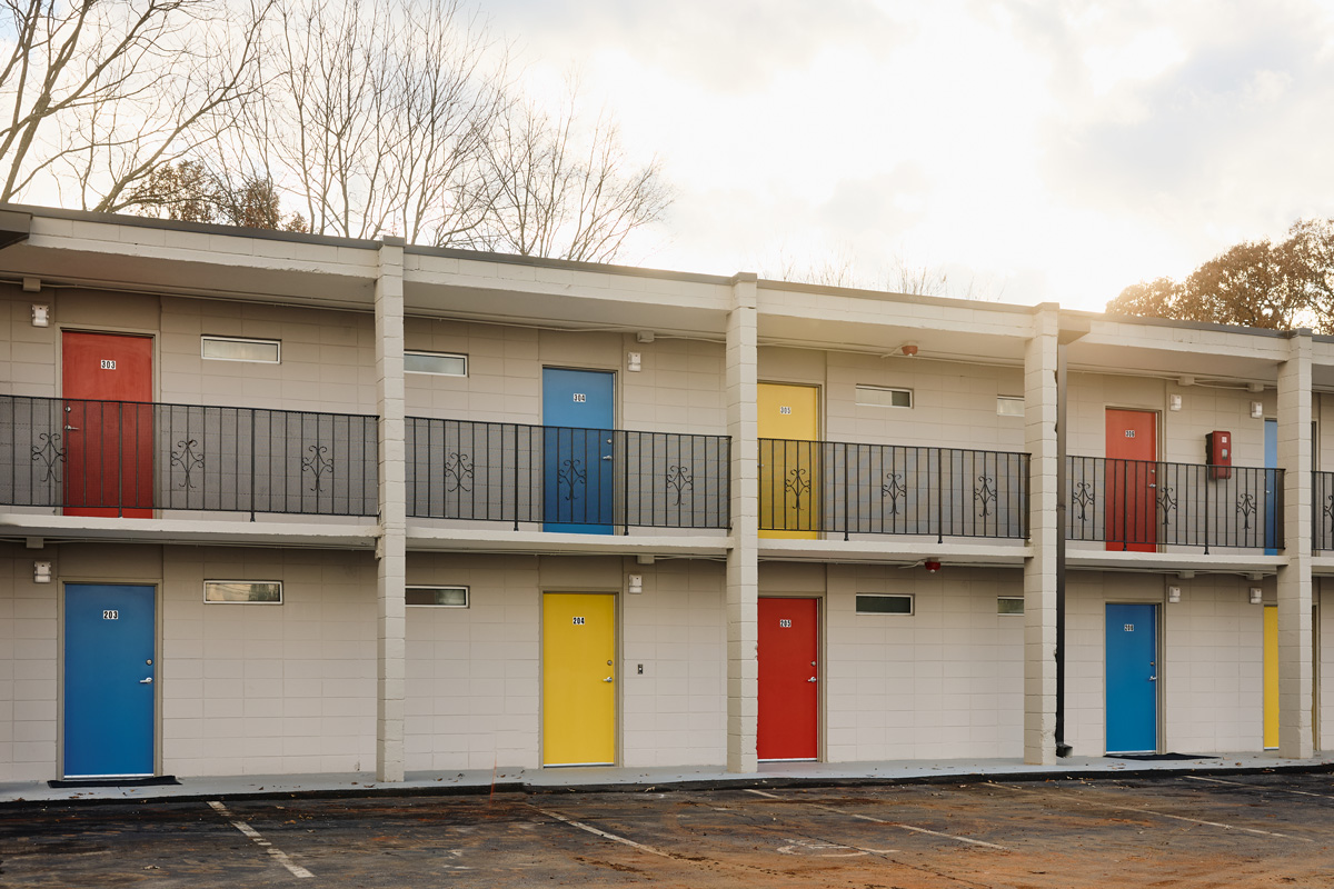 the exterior facade of the apartments, including bright yellow, red, and blue doors