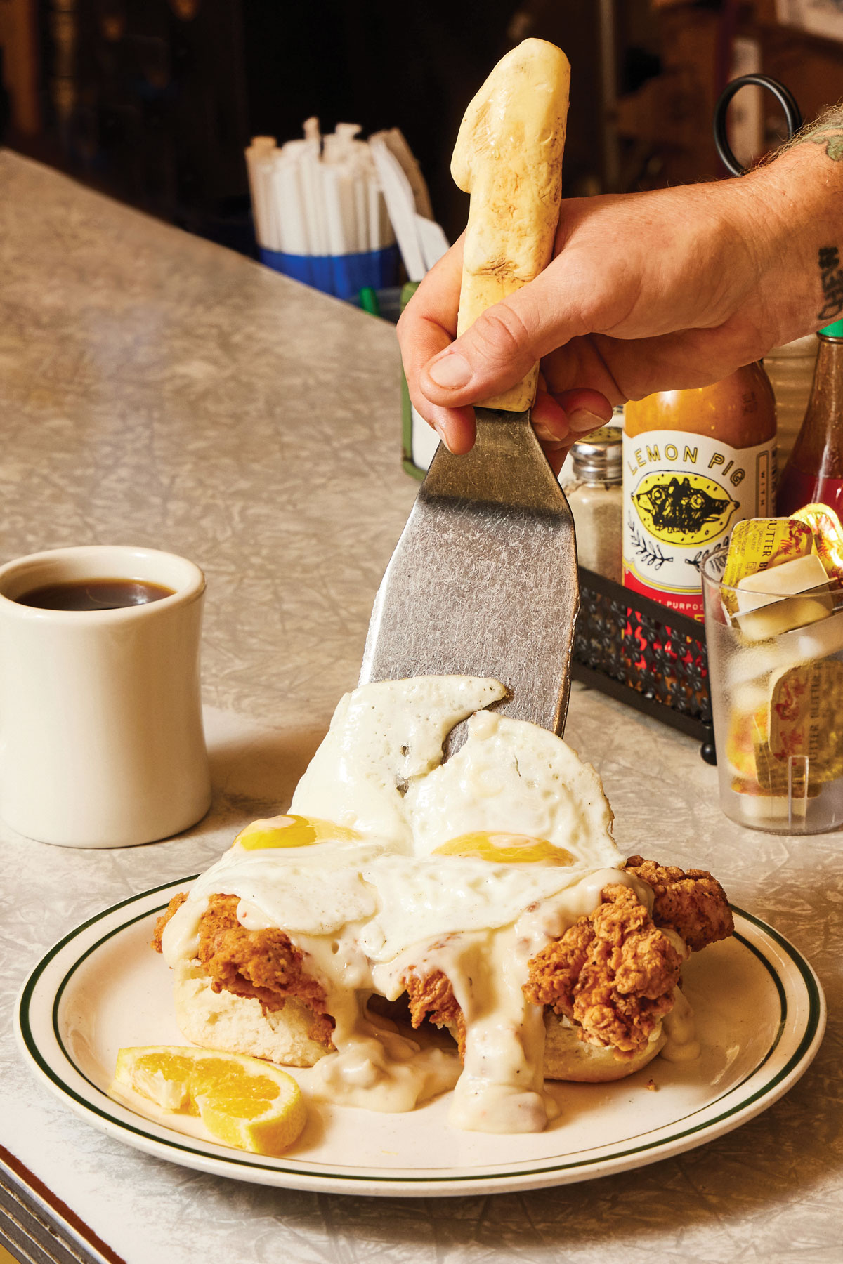 A spatula serves the comfy chicken biscuit onto a plate