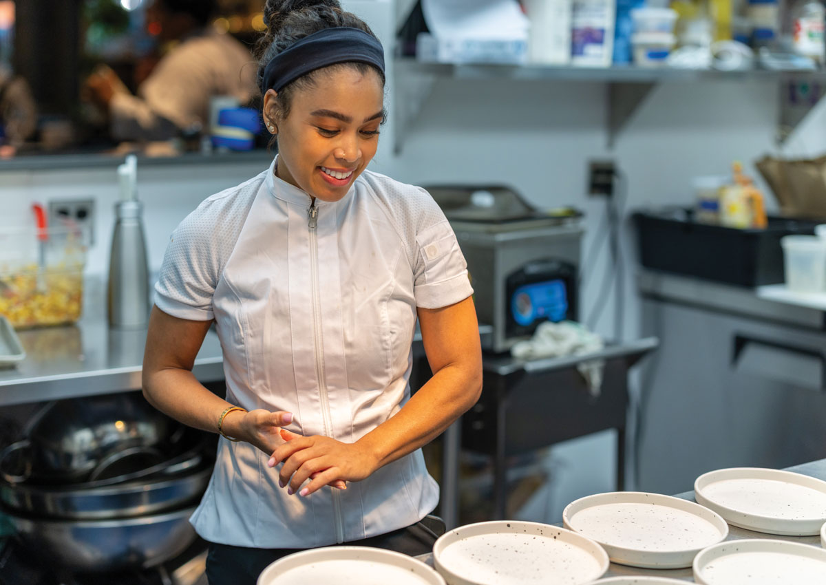 Chef Christan Willis smiles at empty plates