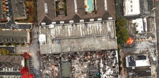 A top-down drone view of the burned down complex