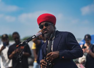 Five “Only In Atlanta” moments from 2025 Andre 3000 with a red hat, speaking into a mic