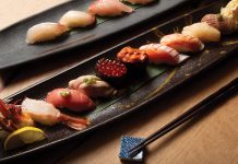 Assorted nigiri on the salvaged wood bar at Nakato