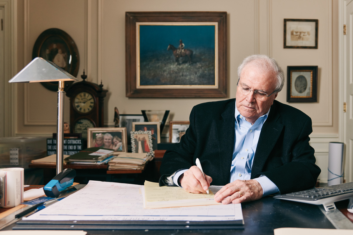 Johnson writes on a notepad in his office