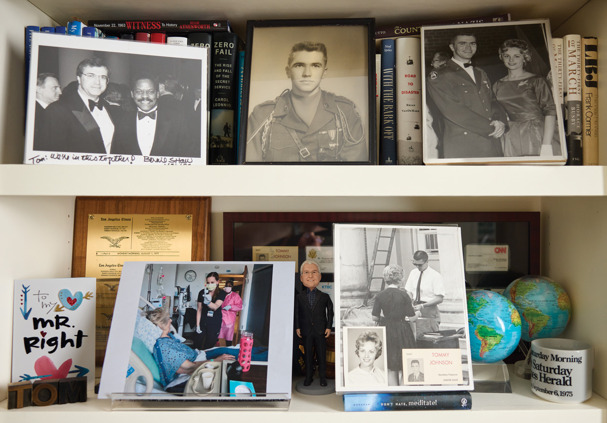 A shelf at Tom Johnson’s house featuring photos and books
