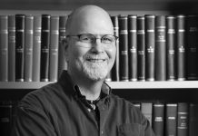 Editor’s Journal: Bon voyage, Atlanta magazine A black and white headshot of Scott Freeman crossing his arms and smiling in front of a bookshelf