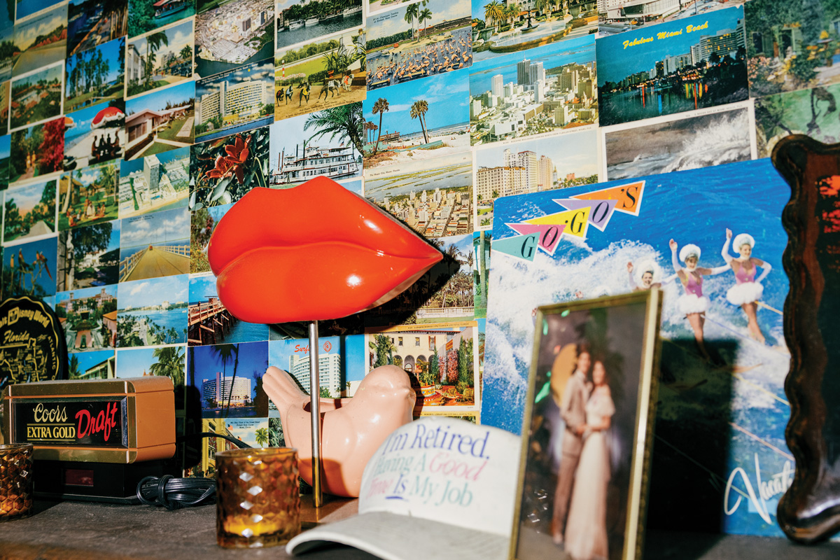 postcards fill the walls along with funk decor like a pair of red lips and a faded graphic white hat