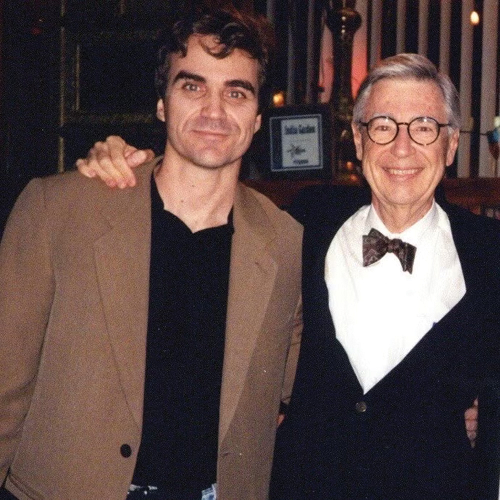 Tom Junod (left), smiles next to Fred Rogers (right)