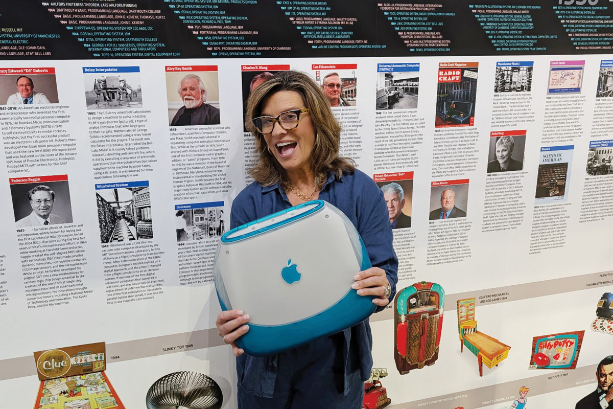 Karin Mimms with a clamshell iBook, which was released by Apple in 1999 and came in five candy-color hues