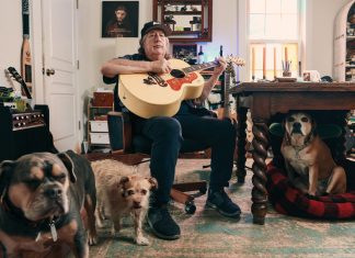 Drivin N Cryin comes full circle with a big-hearted record for Atlanta Kevn Kinney holds a guitar in his home, along with his three dogs surrounding him