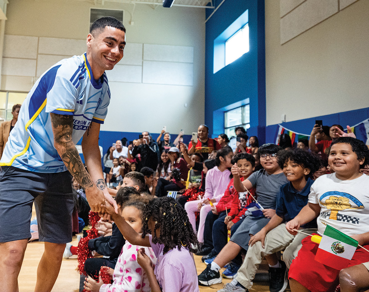 Atlanta United midfielder Miguel Almiron, a native of Paraguay, inspires local children